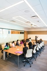 woman running a training session to a room of people