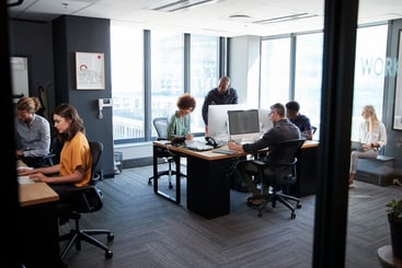 creative team working on computers in an office. mha-kroll-succession-planning-global-tech-firm
